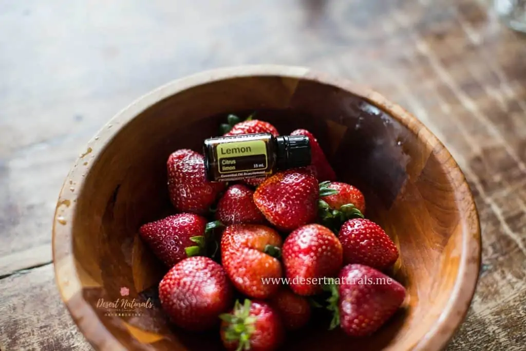 use doterra lemon essential oil in a bowl with water and strawberries to wash and clean the fruit