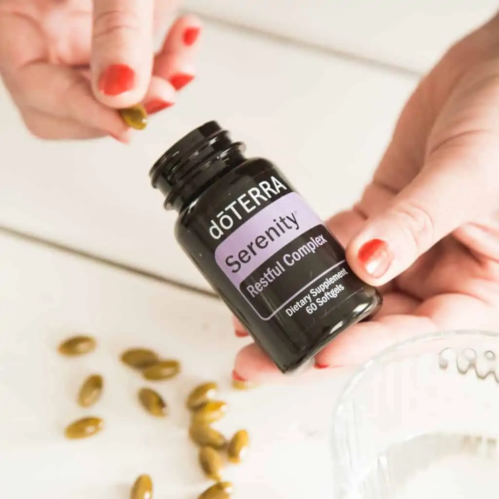 woman's hands with doterra serenity capsules