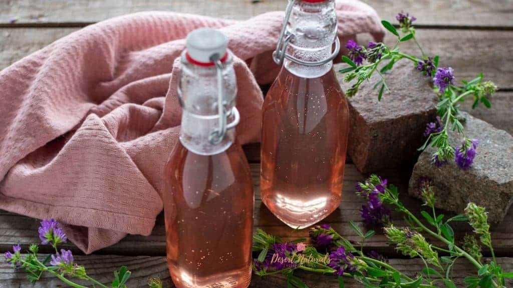 bottles of homemade lavender simple syrup made with essential oil