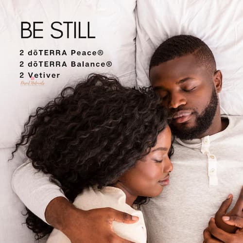woman and man cuddling in bed with text for a sleep essential oil diffuser blend