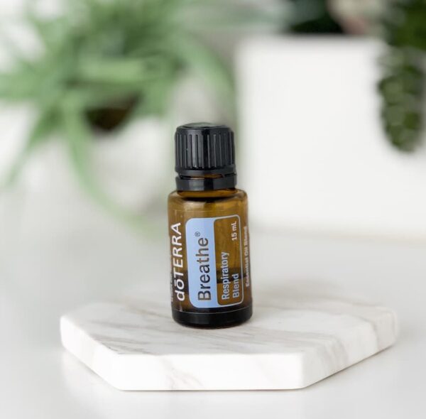 photo of doTERRA Breathe essential oil bottle with plants in the background