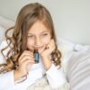 image of girl smelling bottle of doterra breathe essential oil
