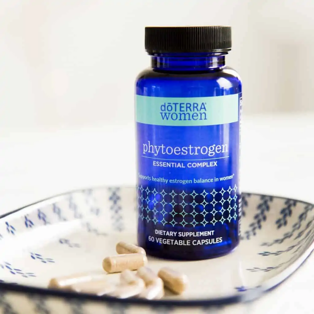 decorative plate with a bottle of doterra phytoestrogen supplement and a few capsules in the plate