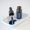 white background with image of doTERRA Blue Tansy essential oil on a tray with a dropper