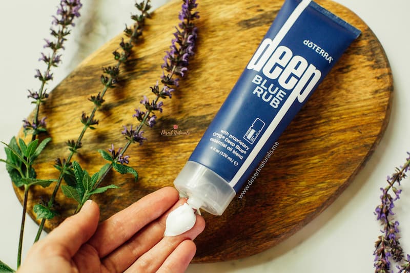 a tub of deep blue rub with a woman's hand