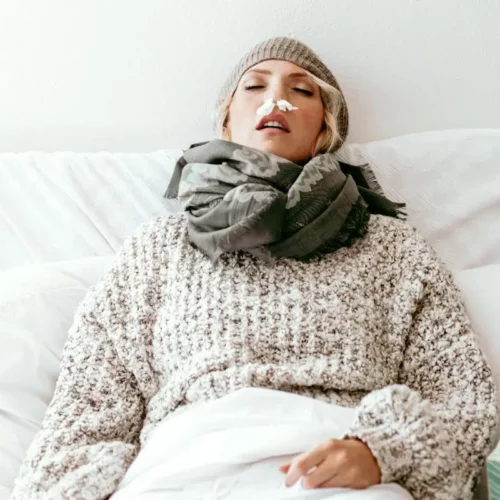sick woman who needs essential oils to boost her immune system