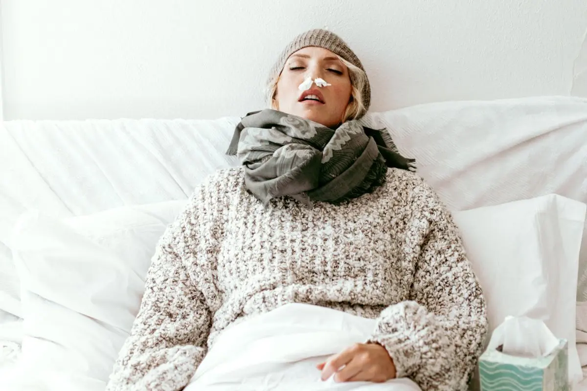 sick woman who needs essential oils to boost her immune system