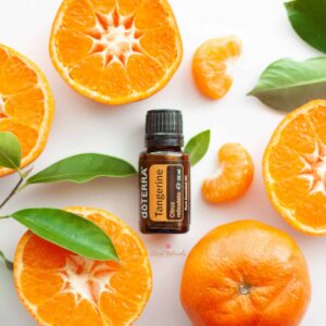 doterra tangerine essential oil surrounded by tangerine fruit