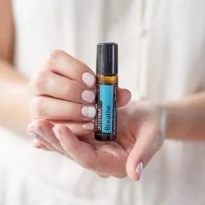 doTERRA Breathe Touch Essential Oil Roller in woman's hands