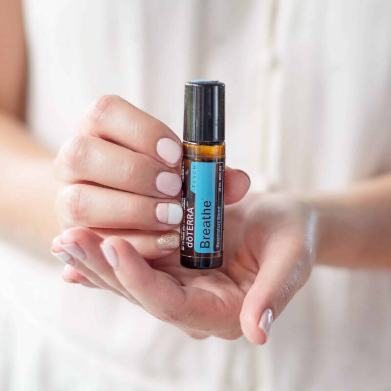 doTERRA Breathe Touch Essential Oil Roller in woman's hands