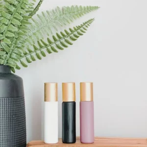 essential oil roller bottles with plant