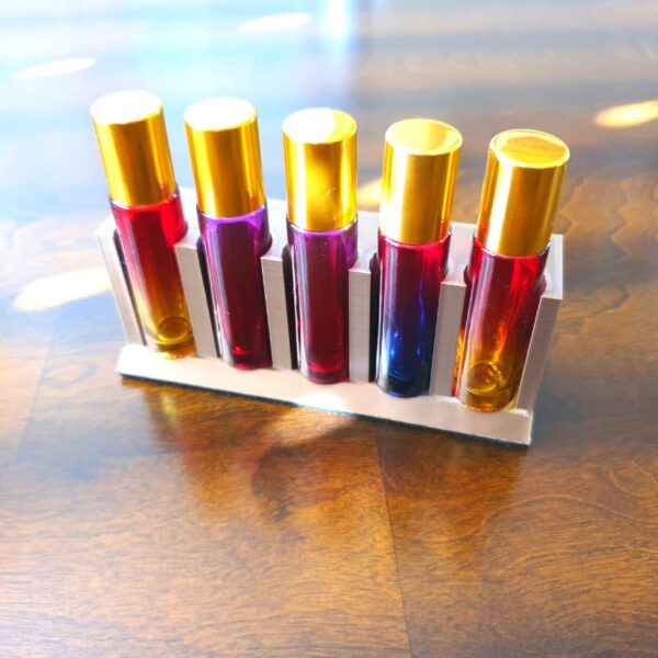 essential oil roller stand with gold top rollers on table