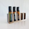 white background with photo of 3d printed essential oil storage stand and doterra rollerballs