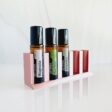 white background with rose gold essential oil storage roller stand