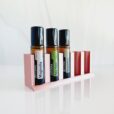 white background with rose gold essential oil storage roller stand