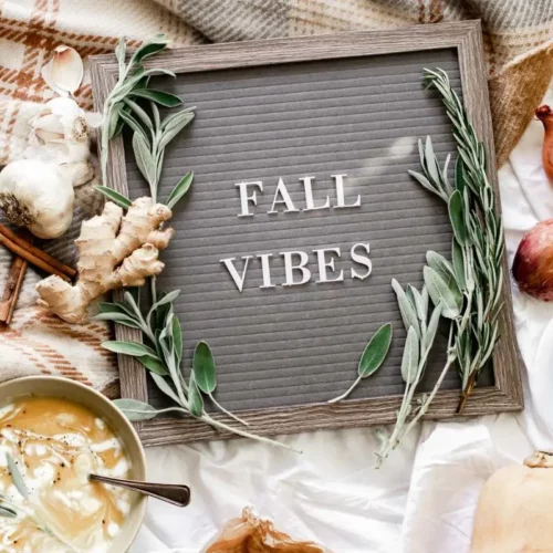fall vibes sign with essential oil bottle, ginger and latte