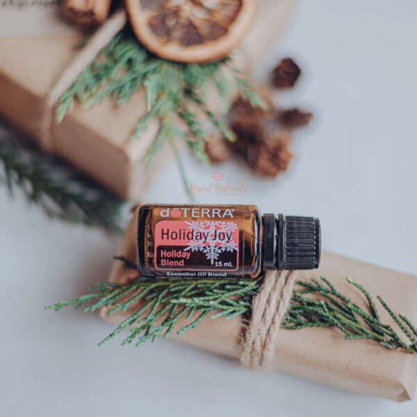 photo of doterra holiday joy essential oil with Christmas presents