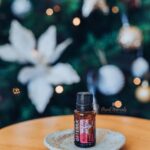 photo of doTERRA Holiday Joy essential oil with Christmas Tree in background