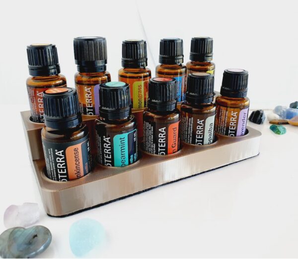 2 level essential oil stand with doterra bottles in it on a white background