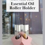 rose gold essential oil roller holder on counter in front of fairy lights with text
