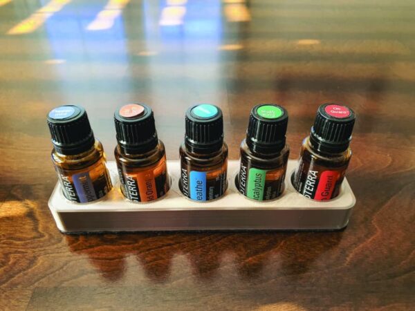 image of 3d printed essential oil holder strip on table with doterra essential oil bottles in it