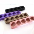 white background with photo of 3d printed essential oil stands in various colors