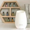doterra portable roam diffuser with essential oils in background