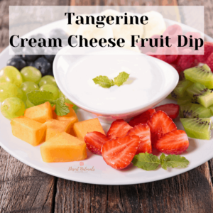 tangerine cream cheese fruit dip with essential oil ads a twist to cut strawberries, kiwi, blueberries, grapes, and cantaloupe