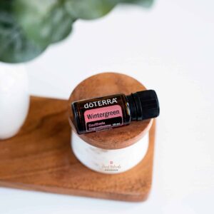 doterra wintergreen essential oil on wood background