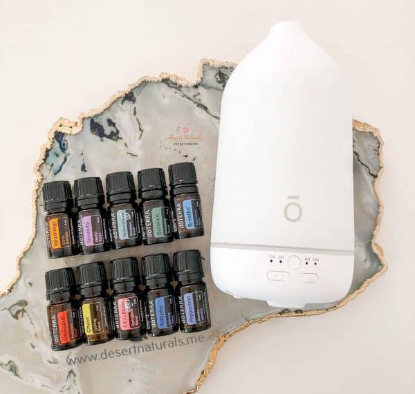 doterra aroma essential kit on wood with laluz diffuser and 10 bottles of essential oil