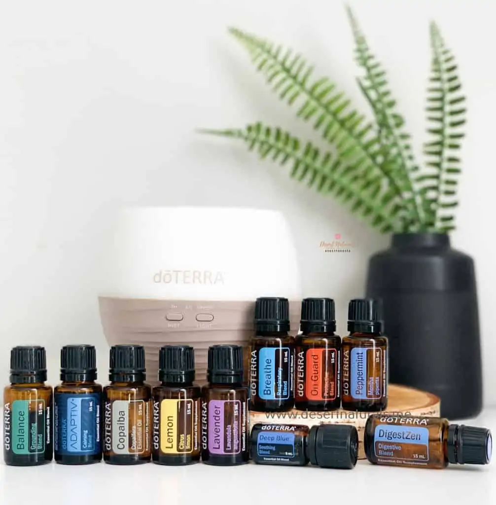 doterra healthy essentials kit with petal diffuser and 15 full size doterra essential oils with plant in the background