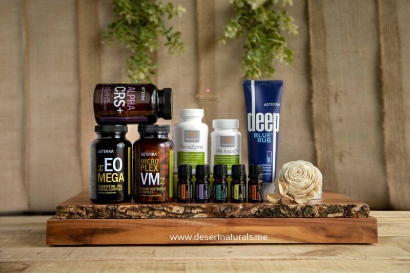 doterra healthy habits kit with natural supplements, vitamins, deep blue rub, and essential oil bottles on wood