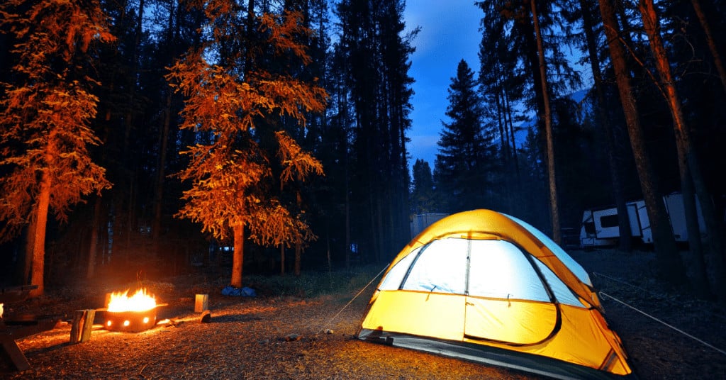 tent camping with campfire - best essential oils for camping