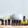 doterra healthy start kit with 10 bottles of essential oil plus a diffuser on wood