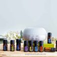 doterra healthy start kit with 10 bottles of essential oil plus a diffuser on wood