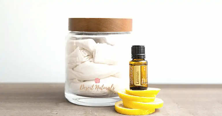 jar of reusable cloth wipes for dusting with a bottle of doterra lemon essential oil on top of lemon peels