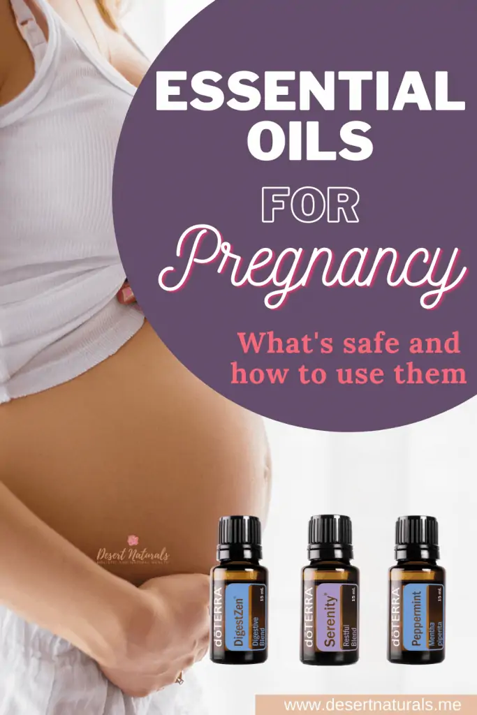 pregnant woman's belly and 3 bottles of doterra essential oil
