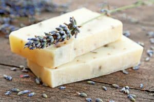 image of diy essential oil lotion bar with sprig of lavender