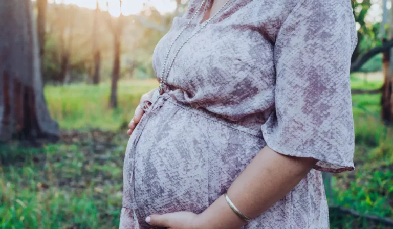 a pregnant woman in a forest setting