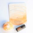 crystal stone with center card and bottle of doterra arise