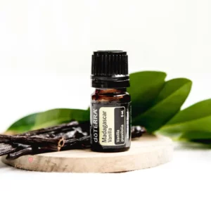 bottle of doterra vanilla essential oil with leaves and vanilla bean pod
