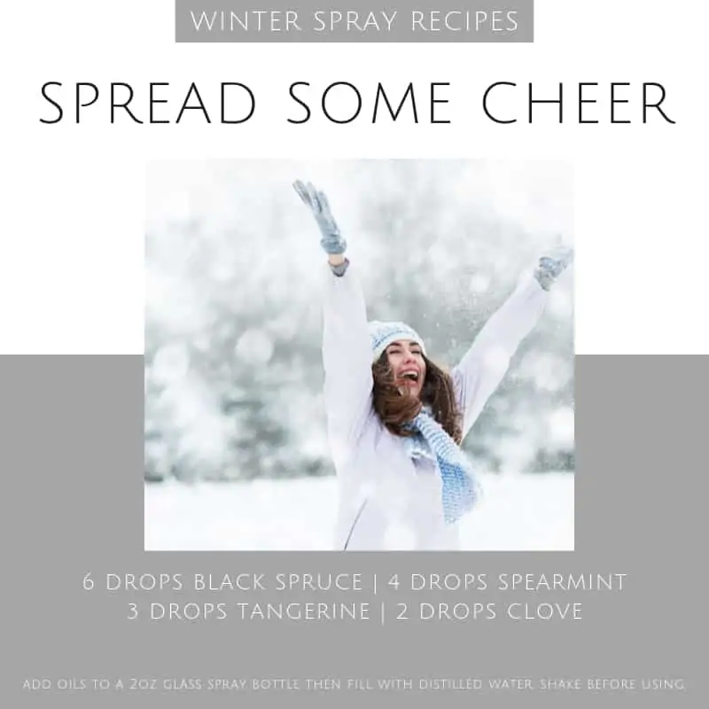 Spread some cheers essential oil spray recipe with image of woman in snow with arms raised in cheer