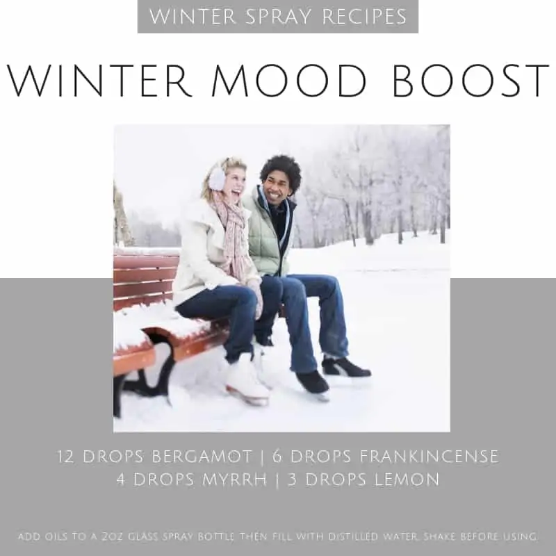 a couple sitting on  park bench in the snow with winter essential oil spray recipe
