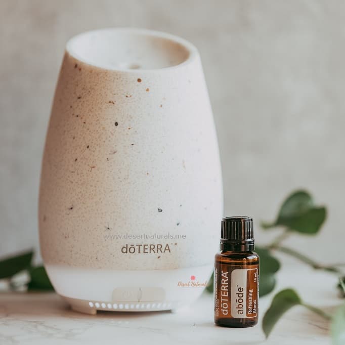 doterra abode oil with roam diffuser and small plant in background