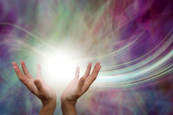photo of 2 hands holding a ball of energy