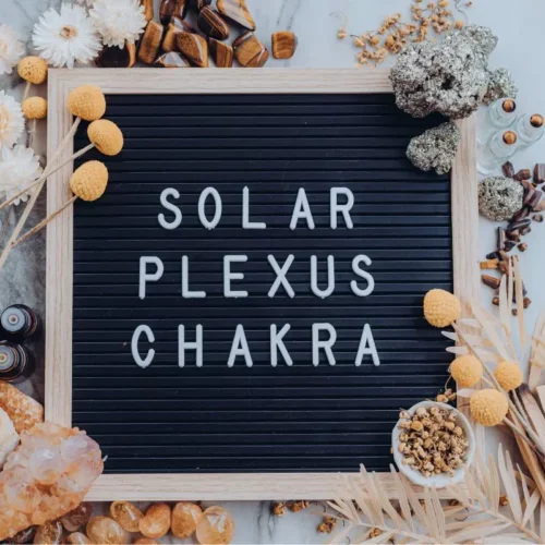 sign with the words solar plexus chakra and essential oils by it