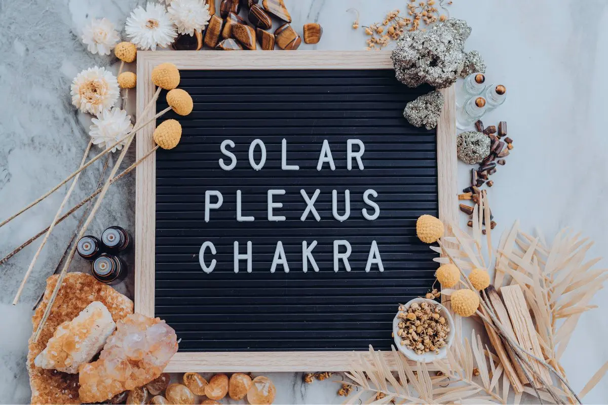 sign with the words solar plexus chakra and essential oils by it