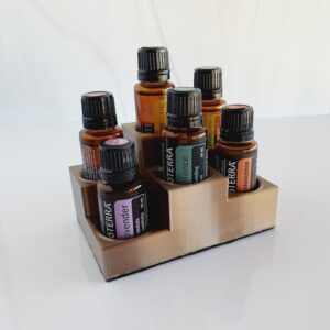 white background with image of champagne gold essential oil display with doterra bottles