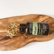 bottle of doterra triease with capsules on a beautiful piece of wood