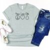 peace love oils essential oil grey shirt flat lay with jeans and tennis shoes